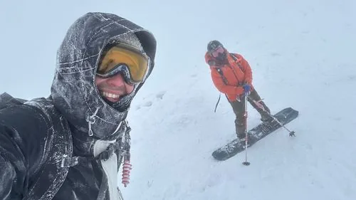 Two skiers on the icy summit of Mt Yotei