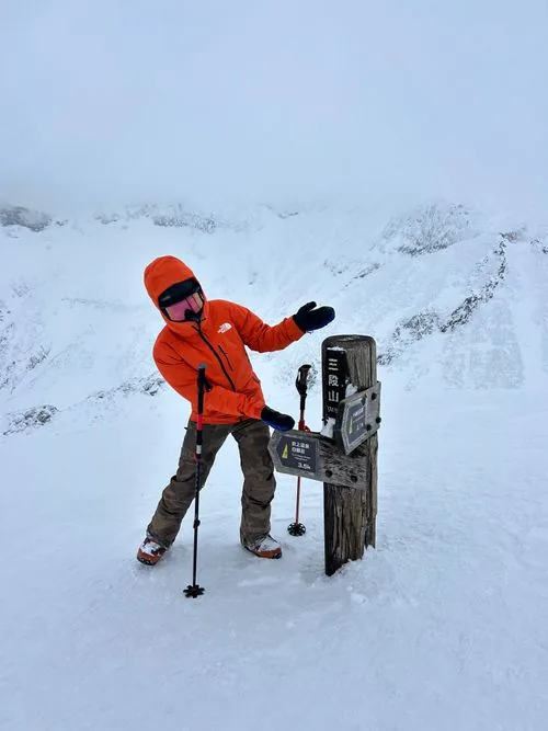 Skier on the summit of Mt Sandan