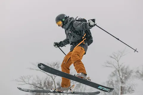 Skier jumping in orange pants