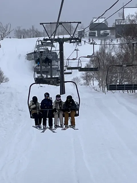 Four friends on a chairlift