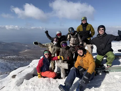 Group of skiers at the top above the sea