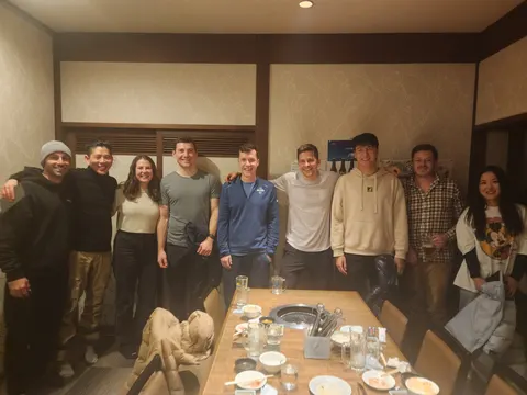Big group of housemates at a restaurant dinner