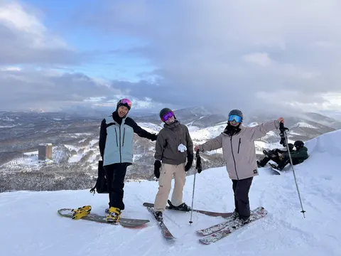 Four friends posing on a ridge with a view
