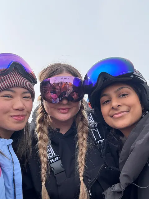 Three friends in ski goggles taking a selfie