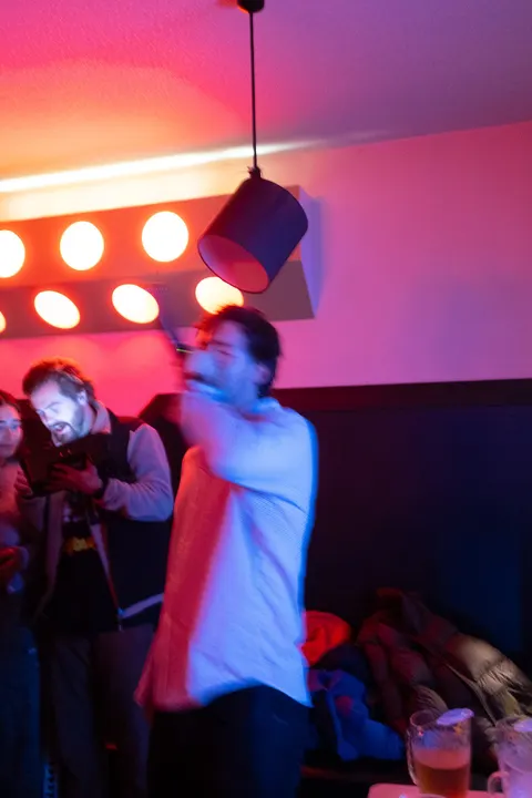 Housemate singing under party lights
