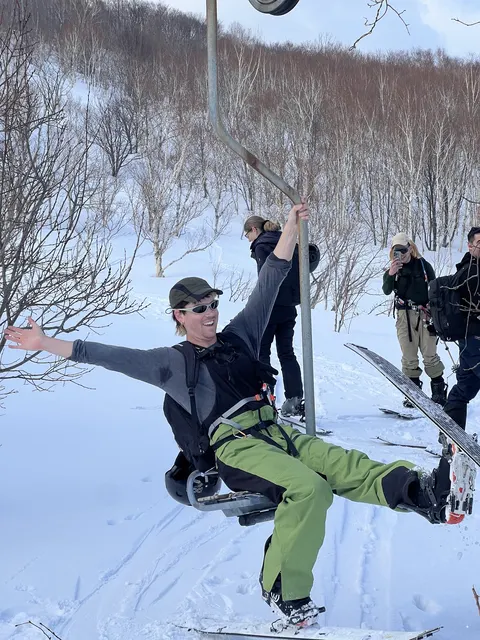 Skier hanging off an old lift tower
