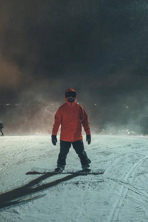 Snowboarder on the slope at night