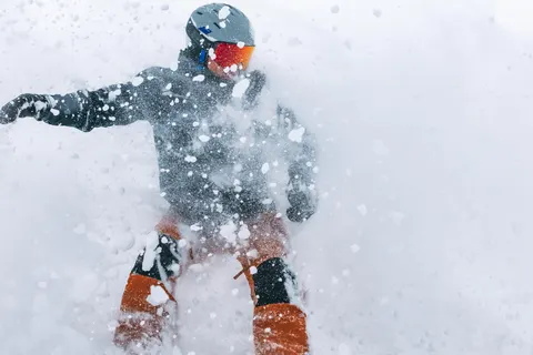 Snowboarder covered in powder spray