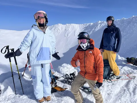 Group at the top under a blue sky