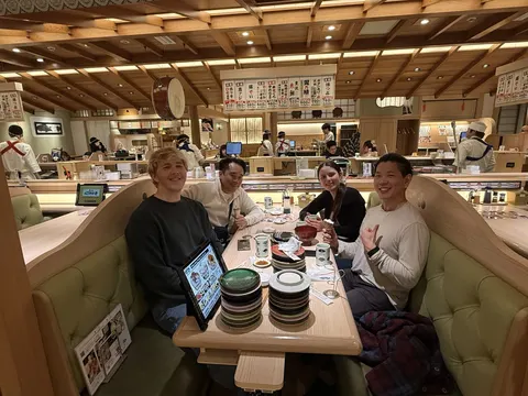 Friends at a conveyor-belt sushi restaurant