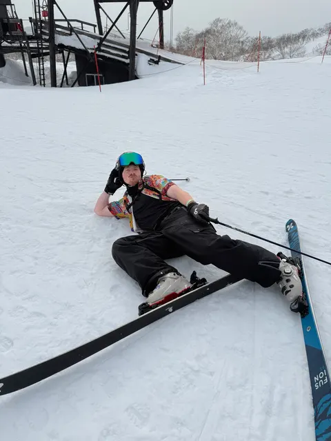 Skier lying on the slope taking a break