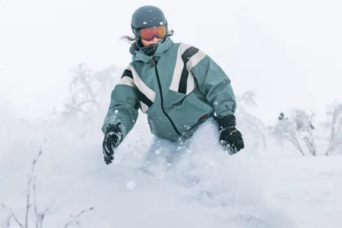 Skier pushing through waist-deep powder