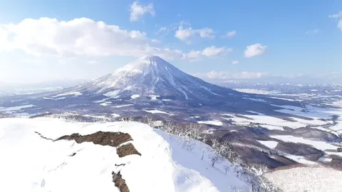 Drone view of a snowy ridge with Mt Yotei