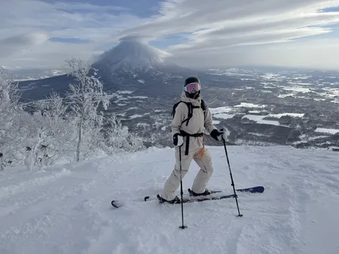 Skier on a ridge with Mt Yotei in the distance