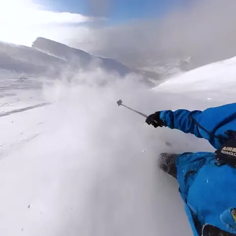 Point-of-view clip skiing an open bowl