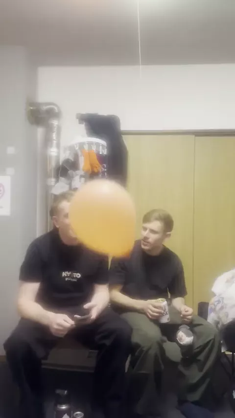 Housemates playing a balloon game in the living room
