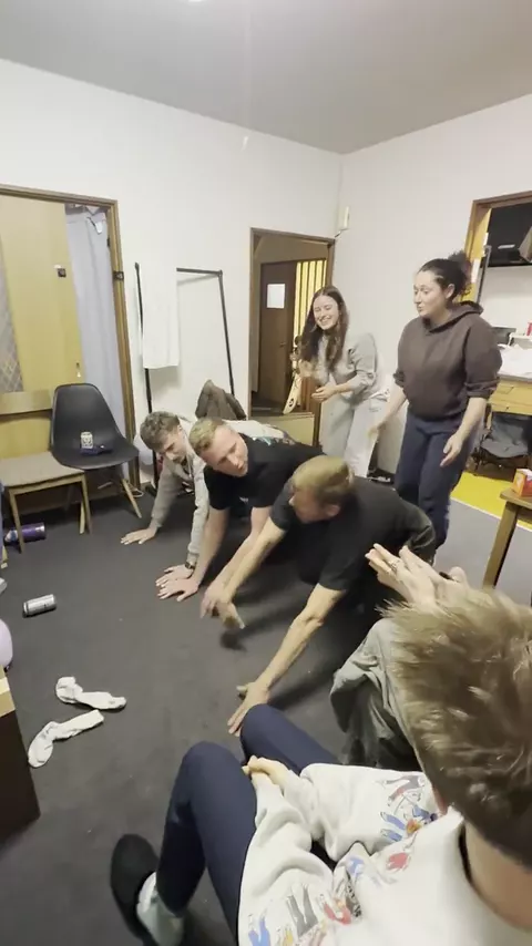 Housemates playing a game in the living room