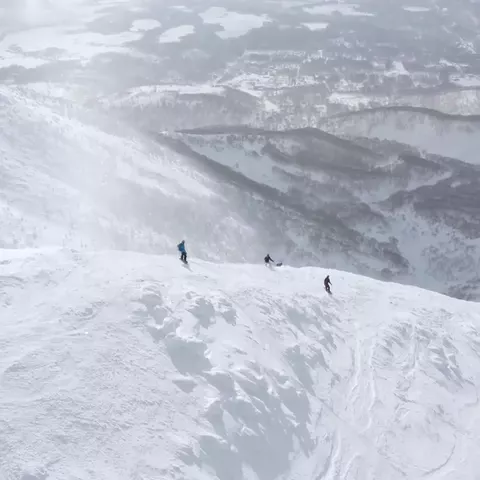 Drone shot of riders on an open slope