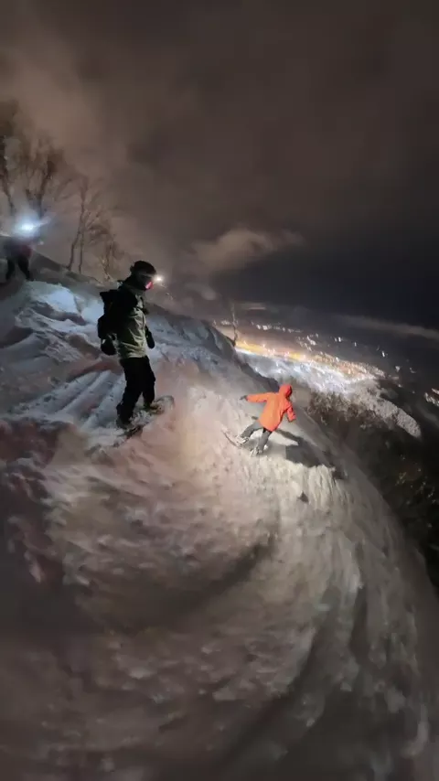 Snowboarding powder at night